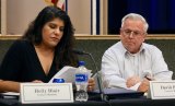 Councilmember Holly Blair reads from a prepared statement as Councilmember Dave Brown looks on.